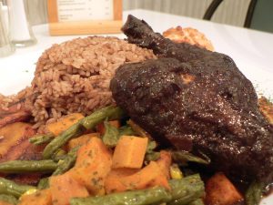 Photo of a typical meal of jerk chicken, rice and peas, breadfruit, plantains and, if you really must, vegetables by Stu Spivack